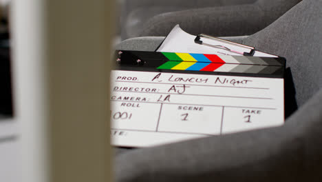 Close-Up-Of-Film-Clapperboard-Or-Slate-With-Production-Details-And-Script-Shooting-Movie-Or-Video-In-Studio-2